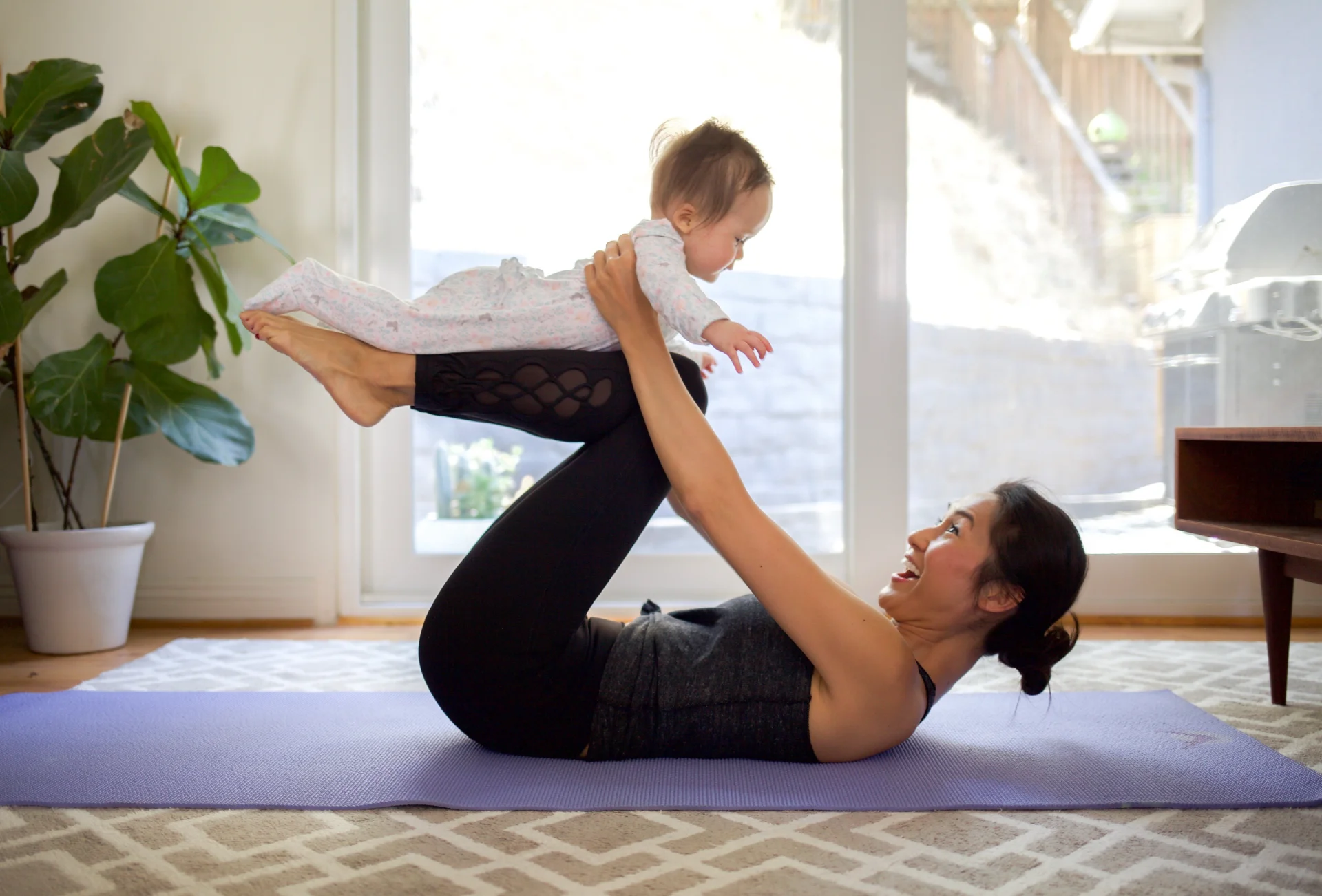adult and infant doing yoga in bright home 2026 01 07 06 25 19 utc